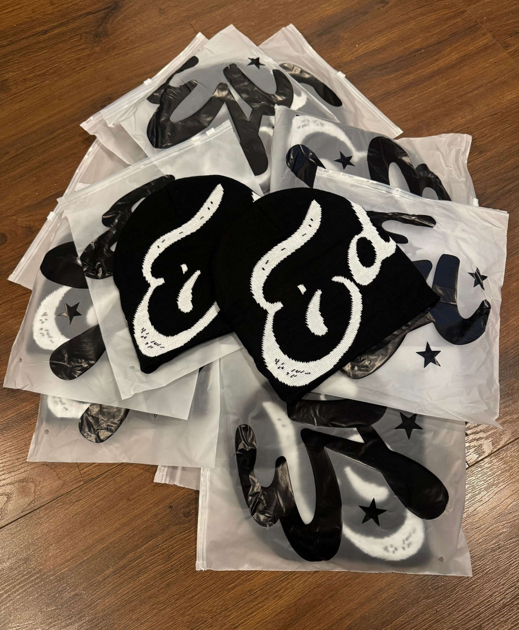 EDEN Cursive Beanie displayed on top of packaging, showcasing the design and material details.